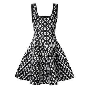 A sleeveless black and white patterned dress with a square neckline and a flared skirt, shown against a plain white background.