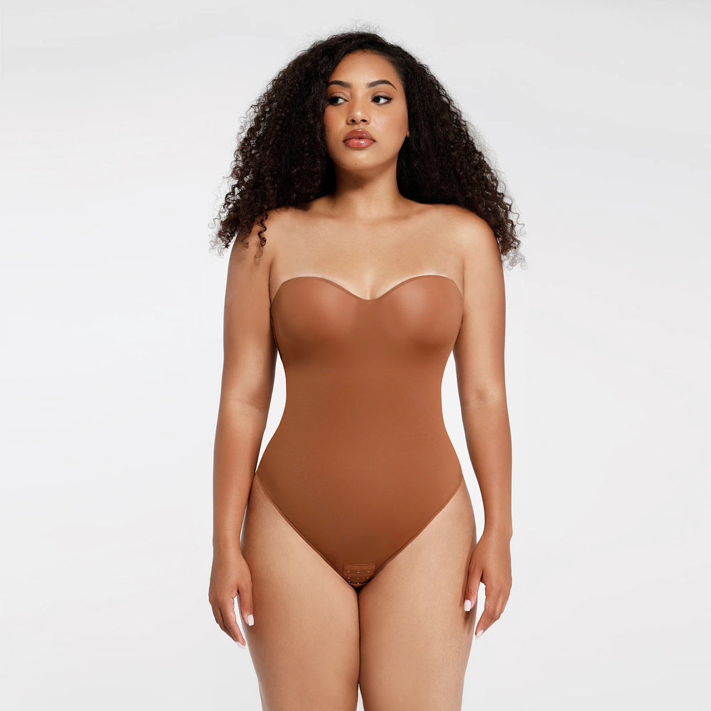 Woman wearing a brown bodysuit against a white background