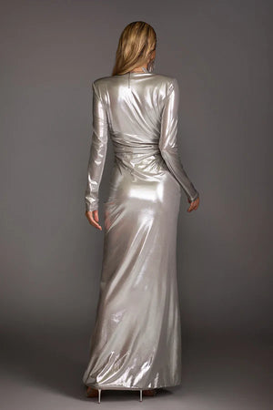 Woman wearing a silver metallic dress against a gray background