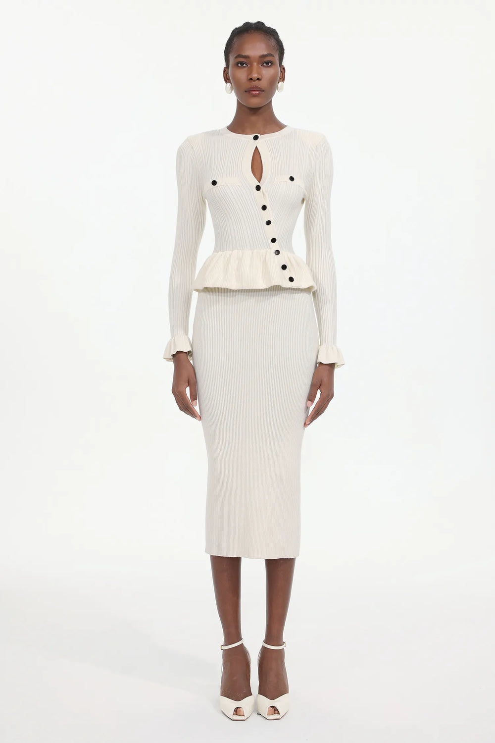 White ribbed dress with black buttons on a white background