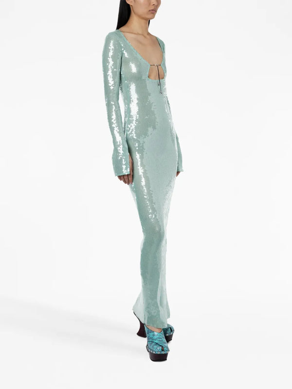 Woman wearing a light blue sequin jumpsuit on a white background