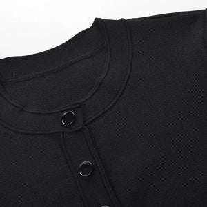 Close-up of a black garment with buttons on a white background