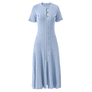 Light blue dress with button details on a white background