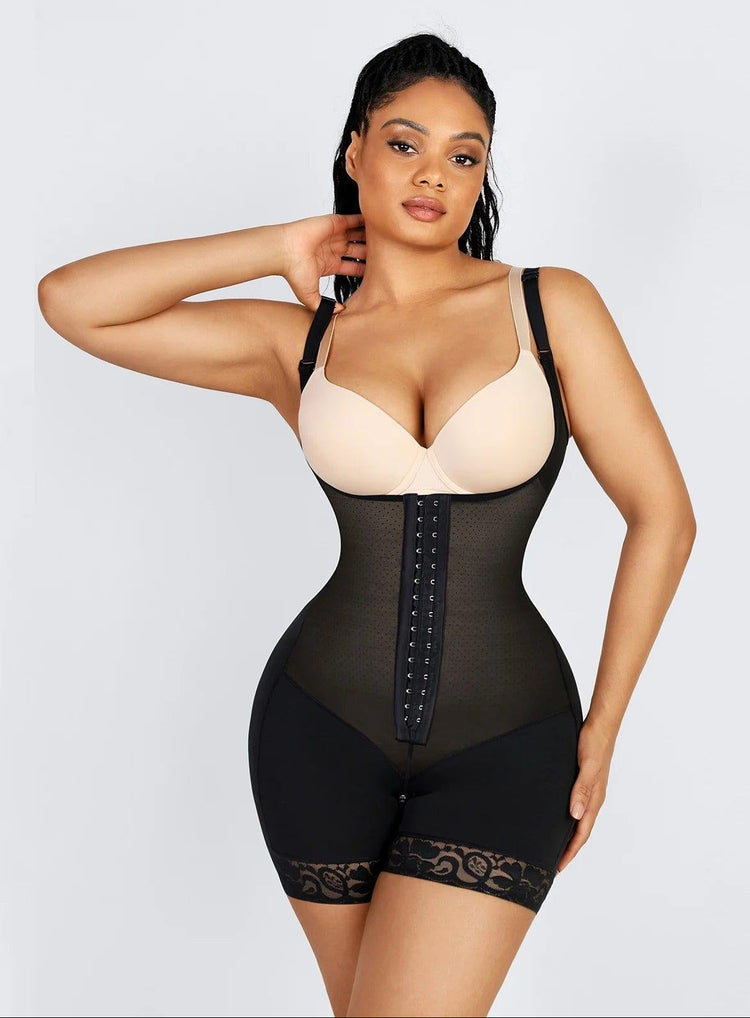 Woman wearing a black waist trainer against a light gray background