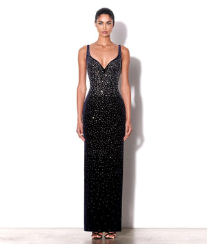 Woman wearing a black sequin evening gown on a white background