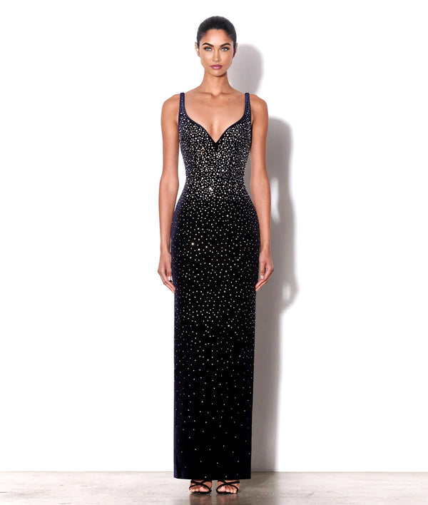 Woman wearing a black sequin evening gown on a white background