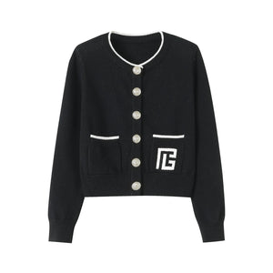 Black cardigan with white buttons and a logo on a white background