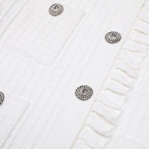 Silver earrings on a textured white surface