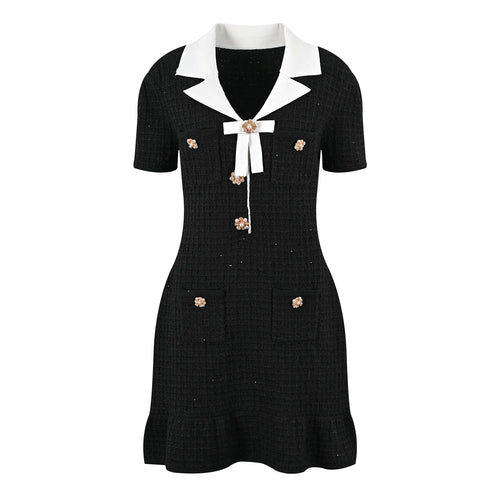 Black dress with white collar and gold buttons on a white background