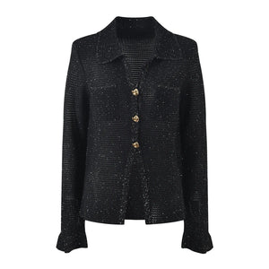 Black textured jacket with gold buttons on a white background