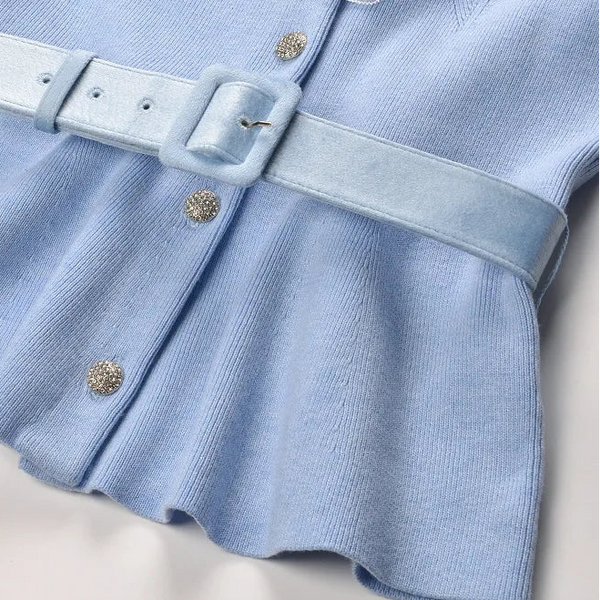 Light blue dress with a belt on a light background