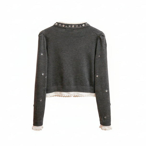 Dark gray embroidered jacket on a wooden hanger against a neutral background
