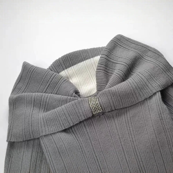 Gray ribbed sweater with a decorative button on a white background
