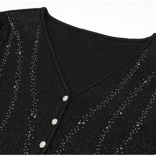 Black glittery top with button details on a white background