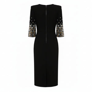 Black dress with embellished sleeves on a white background