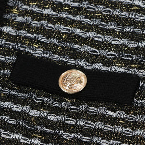 Close-up of a textured fabric with a button featuring a face design.