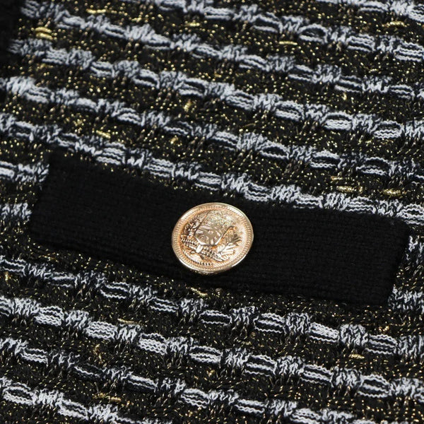 Close-up of a textured fabric with a button featuring a face design.