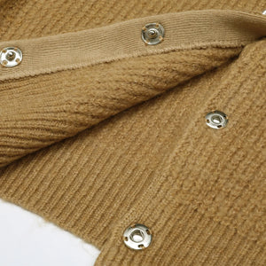 Close-up of brown fabric with metal buttons on a white background