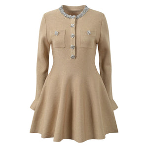Beige dress with decorative buttons on a white background