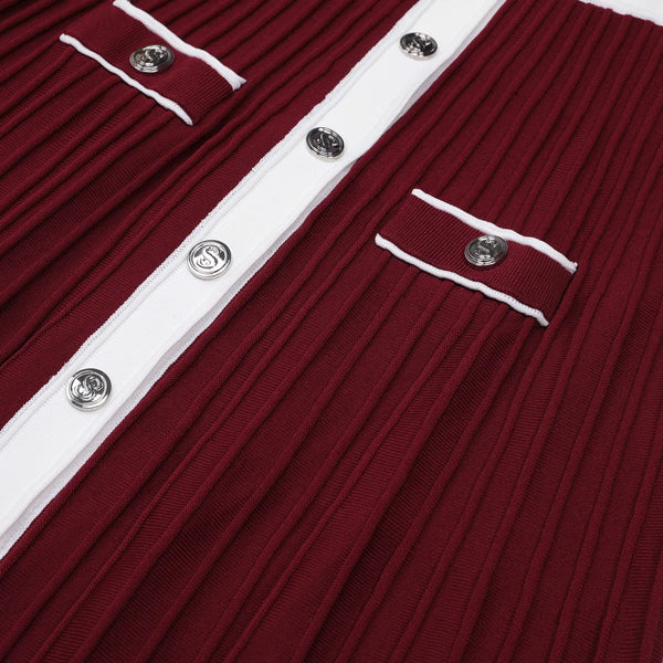 Close-up of a red ribbed garment with white trim and silver buttons.