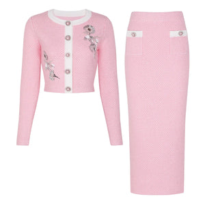 Pink textured dress with floral embellishments on a white background