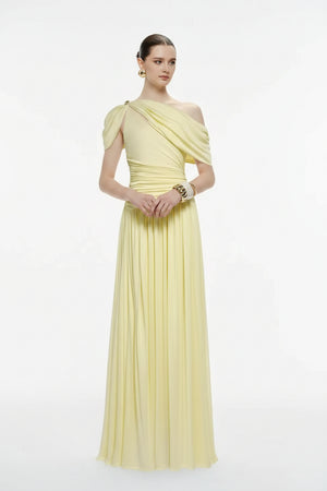 Woman wearing a light yellow one-shoulder dress on a white background