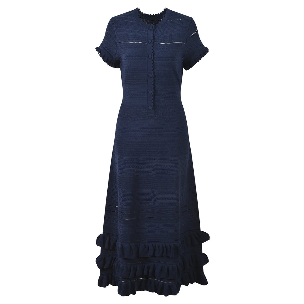 Navy blue dress with ruffled details on a white background