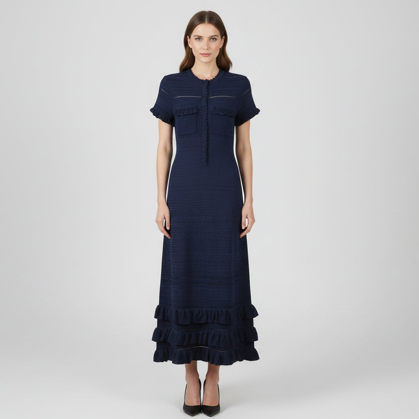 Navy blue dress with ruffled details on a white background