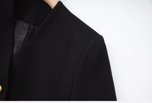 Close-up of a black garment with a textured pattern on a white background