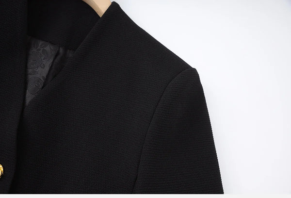 Close-up of a black garment with a textured pattern on a white background