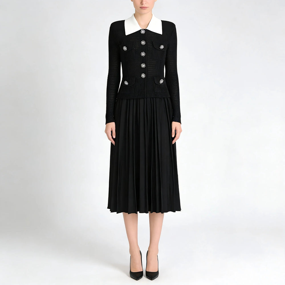 Black dress with white collar and embellishments on a white background