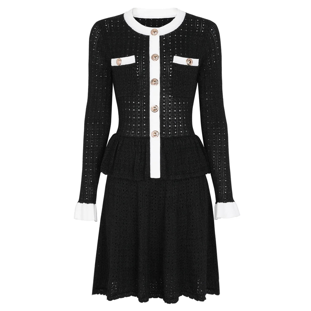 White dress with black accents and buttons on a white background