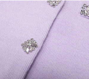 Close-up of a lilac fabric with decorative buttons.