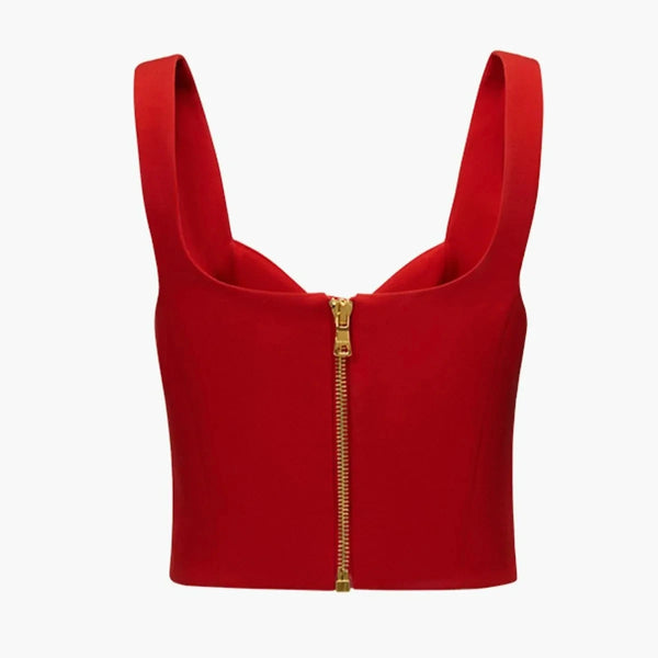 Red crop top with a gold zipper on a white background