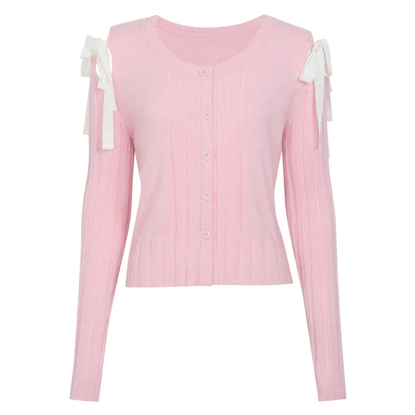 Pink long-sleeve top with white bow details on a white background