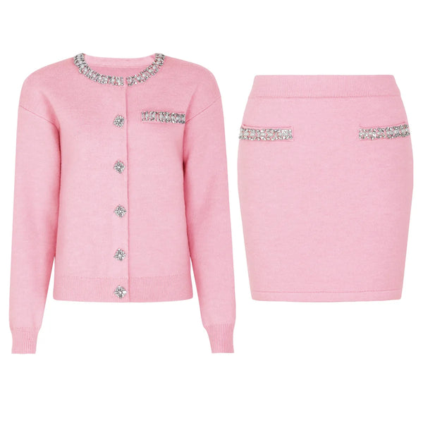 Pink cardigan and skirt set with embellishments on a white background