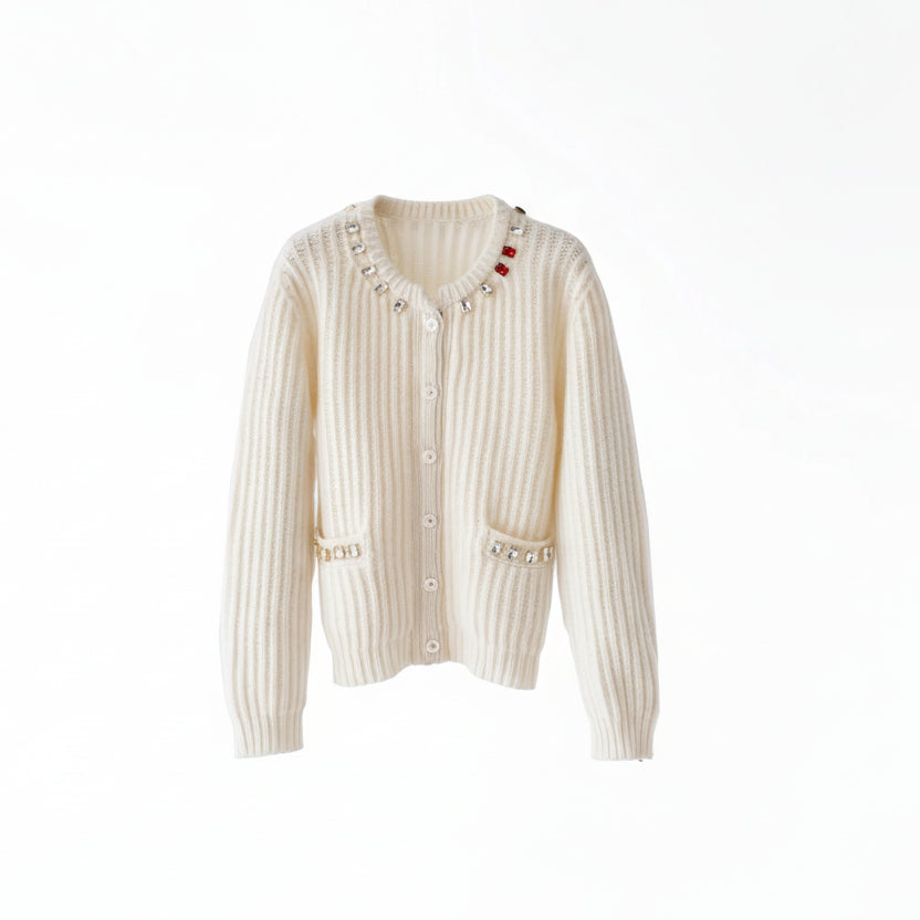 White ribbed sweater with decorative buttons on a wooden hanger against a white background