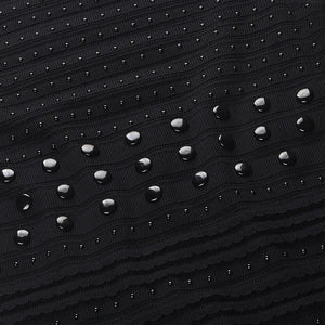 Black textured fabric with embedded silver studs on a white background