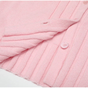 Close-up of a pink textured fabric with a button on a white background