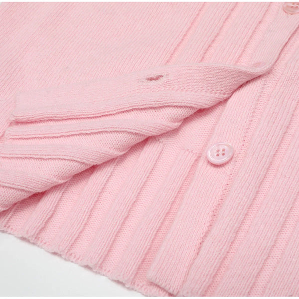 Close-up of a pink textured fabric with a button on a white background