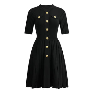 Black dress with gold buttons on a white background