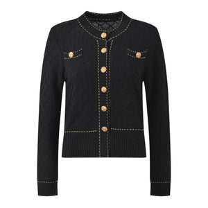 Black quilted jacket with gold buttons and trim on a white background
