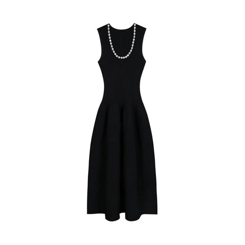 Black dress with a pearl necklace on a white background