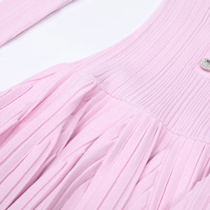 Close-up of a pink textured fabric with a small decorative element.