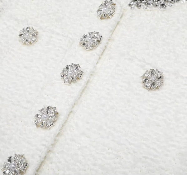 Close-up of diamond earrings on a white textured background