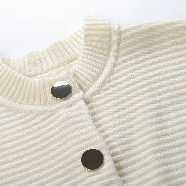 Close-up of a cream-colored corduroy jacket with black buttons on a white background
