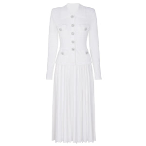 White pleated dress with button details on a white background