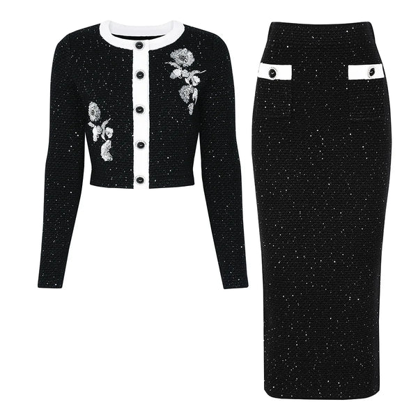 Black embroidered jacket and skirt set on a white background