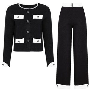 Black outfit with white accents on a white background