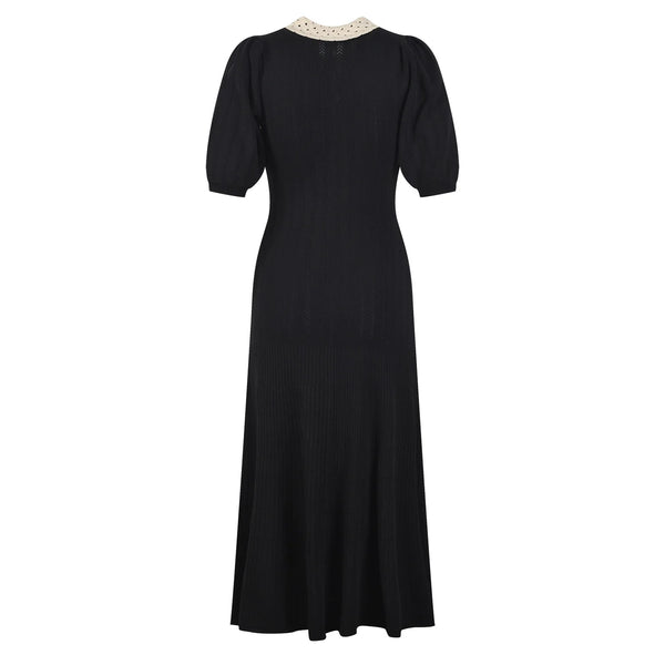 Black dress with a white collar on a white background